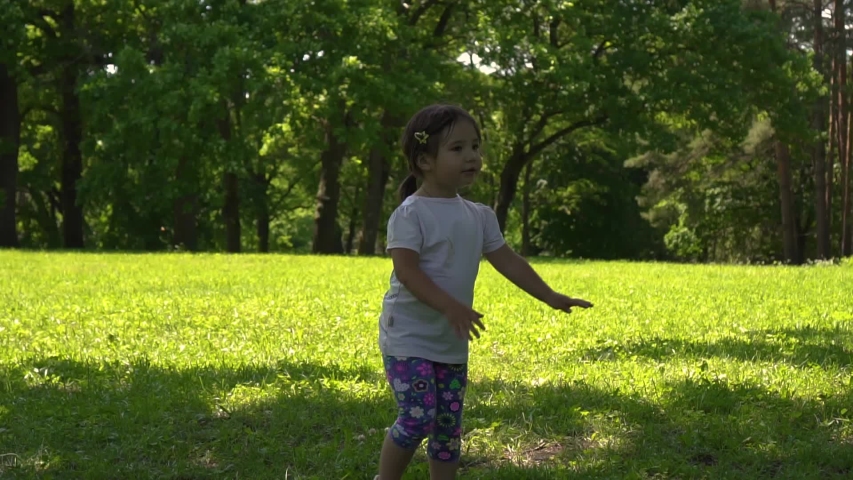 little asian girl doing exercises in the park, day