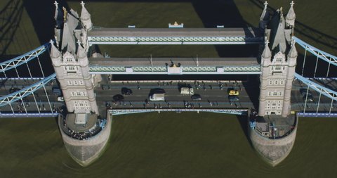 Aerial view of the Tower Bridge over Thames River an iconic symbol of London. Commuters and traffic passing by. Shot on Red Weapon 8K.