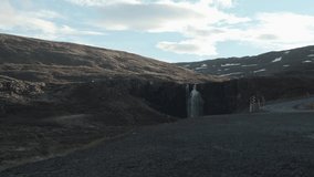 Panning footage showing Gufufoss and the mountains surrounding it. Recorded in Iceland.