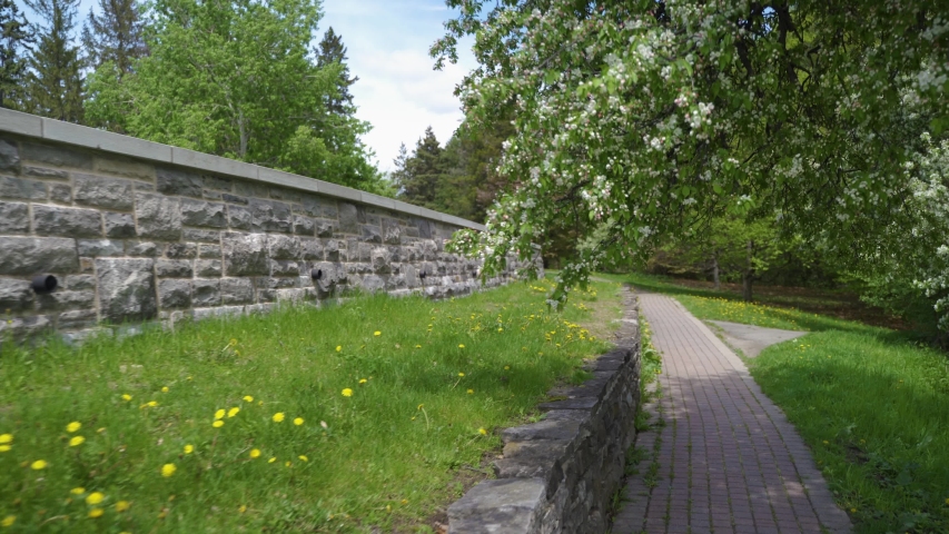 Stonewall path with trees and grass in background in Ontario, Canada