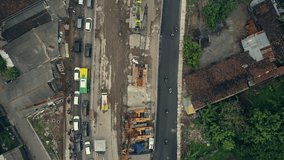 Aerial footage top view of heavy equipment in road construction in Yogyakarta city, Indonesia
