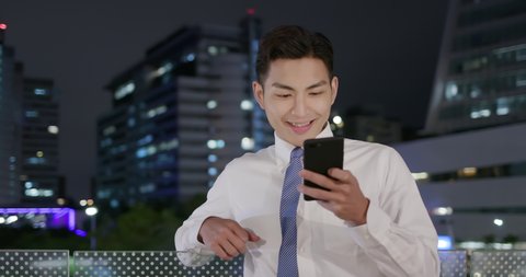 businessman use smart phone outdoor in the evening