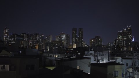 Shinjuku skyline and rooftops in Tokyo, Japan - Wide Static Night shot