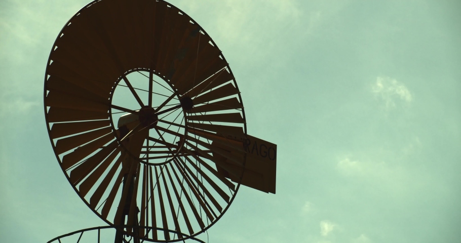 Vintage windmill silhouette blue sky