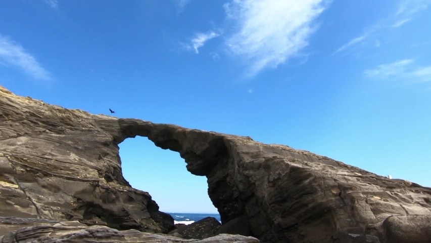 A cave in the blue sky and the seaside