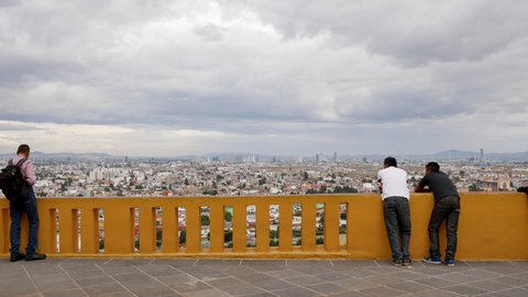 Panoramic view of Puebla city with tourist seen from Great Pyramid of Cholula, Lady of Remedies Church, Puebla, Mexico, in June 2, 2019.