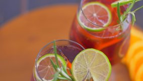 Refreshing sangria cocktail with fruit and ice. Turn around.