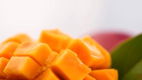 Ripe Mango fruit rotating over white background. Close-up of fresh juicy tropical mango, healthy sweet dessert, vegan food. 4K UHD video