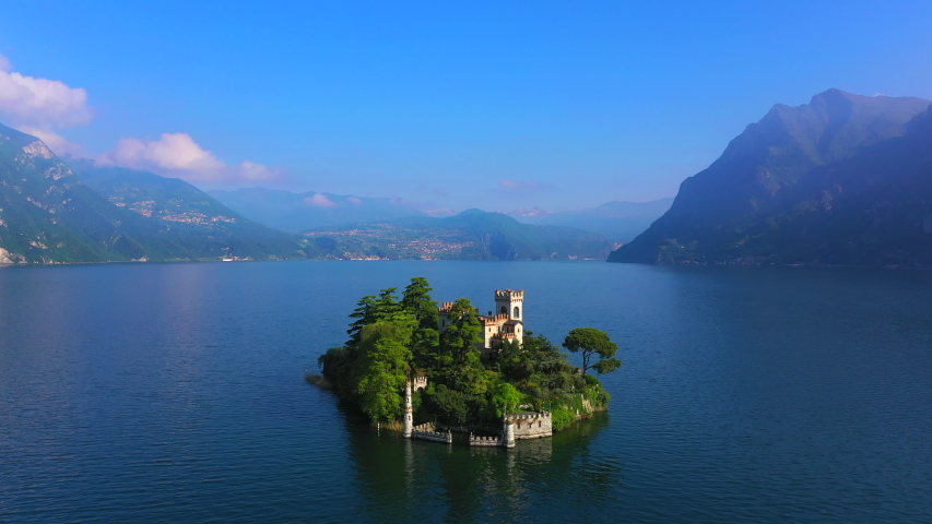 Aerial video with drone. The beautiful island of Loreto on Lake Isola, Italy.