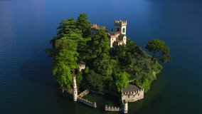 Aerial video with drone. The beautiful island of Loreto on Lake Isola, Italy.