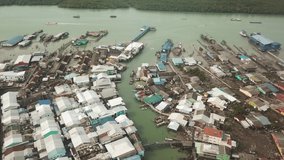 Drone view of fishing boats and village of pulau ketam, malaysia