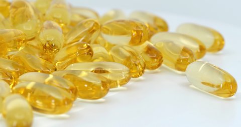 gold capsule oil gel supplement rotating movement, Omega 3 Fish Oil.