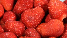 Fresh red Strawberries rotate, closeup video. Many juicy ripe berries strawberries. Strawberry background.