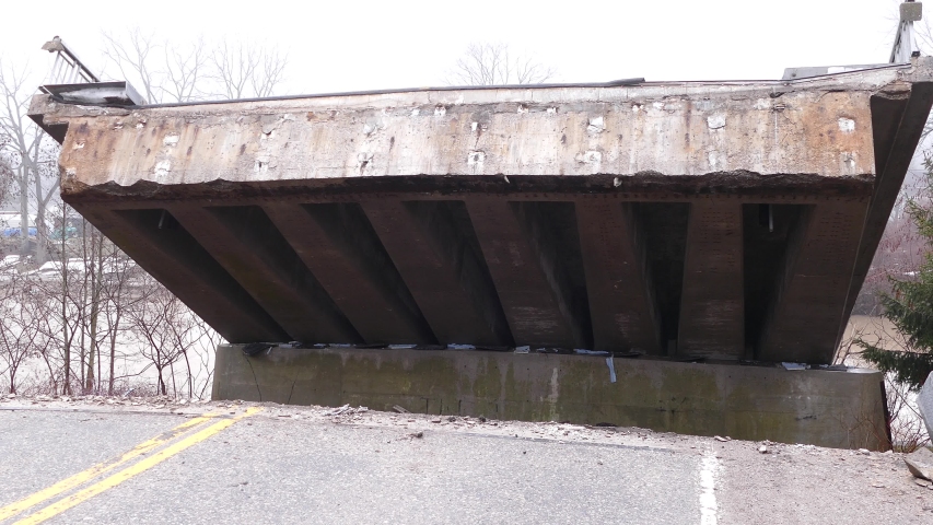 Massive flooding and bridge collapse into river after heavy rain storm
