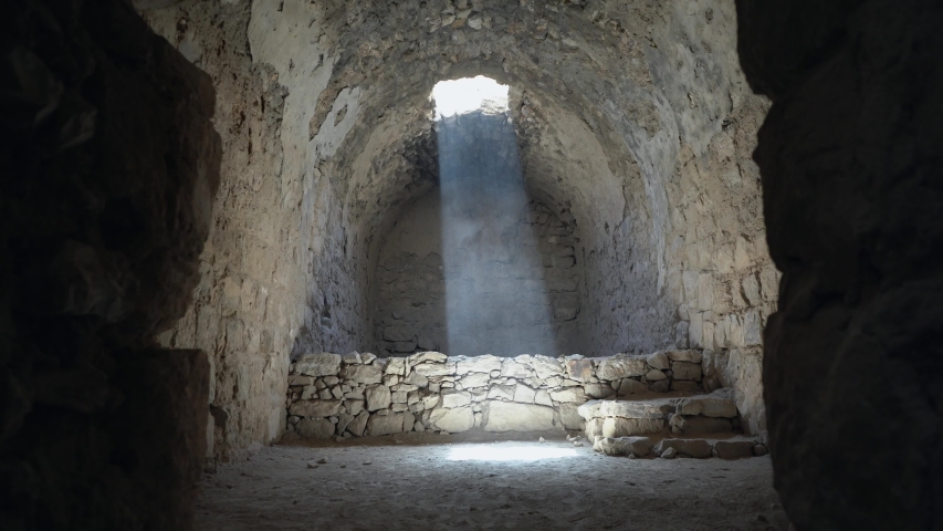 
Free runner runs and jumps at summer. Morning run. Sunlight and sunrays getting into the long dark tunnel cut through the rock.