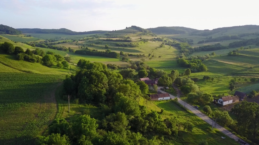 Beautiful aerial view of houses and surrounding from a green romanian village. Beautiful landscape in summer day. 4k