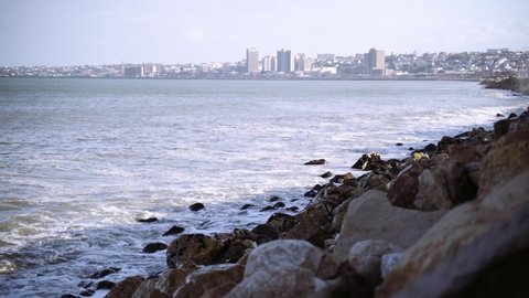 Wide panorama of Port Elizabeth, in the eastern cape of South Africa, from across rocks and sea.