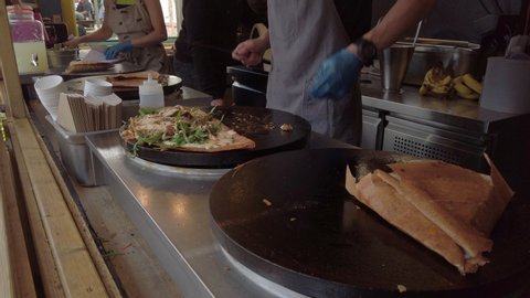 Savoury crepes being cooked on an open-air hotplate at a market stall in York, UK