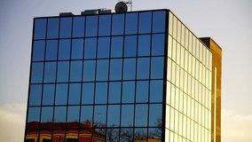 Glass and concrete building with the reflection of an older building on the facade, at sunset with a pink sky - Powered by Shutterstock - Get 15% off with code: PIKWIZARD15