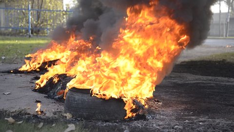 Flames and smoke emanating  from tires on fire on the street during a labor strike and protest at Rosario city, Argentina