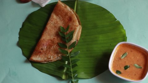 Rotating masala dosa,South Indian meal Set Dosa ,sambhar and coconut chutney on green background