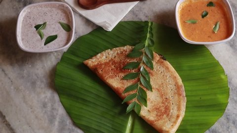 Rotating Masala Dosa / Indian Savory Crepes with potato filling , top down view