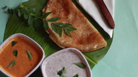 Rotating masala dosa,South Indian meal Set Dosa ,sambhar and coconut chutney on green background
