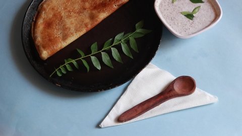 Rotating Dosa - South Indian Breakfast crepes served with chutney and sambar, top view