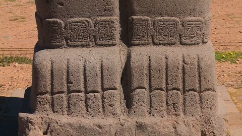 Extreme close-up high angle still shot of front carvings on Ponce Monolith legs at Tiwanaku, La Paz, Bolivia