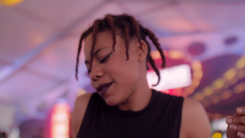 Happy young African woman dancing in the party young people enjoy music having fun with friends young people urban lifetyles