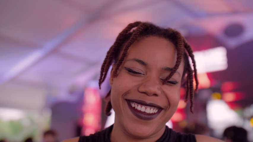 Happy young African woman dancing in the party young people enjoy music having fun with friends young people urban lifetyles