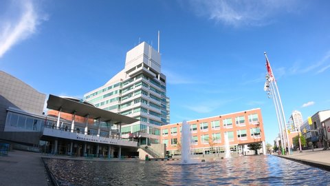 Kitchener, Ontario/Canada - June 3, 2019: Time lapse of modern City Hall with water fountains and reflecting pool in Kitchener, Waterloo Region, Ontario, Canada