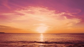 Red sunsets over sea video 4K. The sun touches horizon. Red sky, yellow sun and amazing sea. Summer sunset seascape. Atlantic Ocean beach sunsets. The sun in spindrift clouds Fantastic natural sunsets