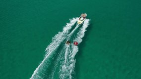 Aerial drone video of extreme power boat donut water-sports cruising in high speed in tropical turquoise bay