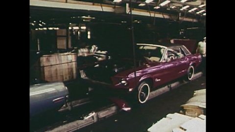 CIRCA 1960s - The interior of a car factory in 1968 with American workers UAW making Ford Mustangs.