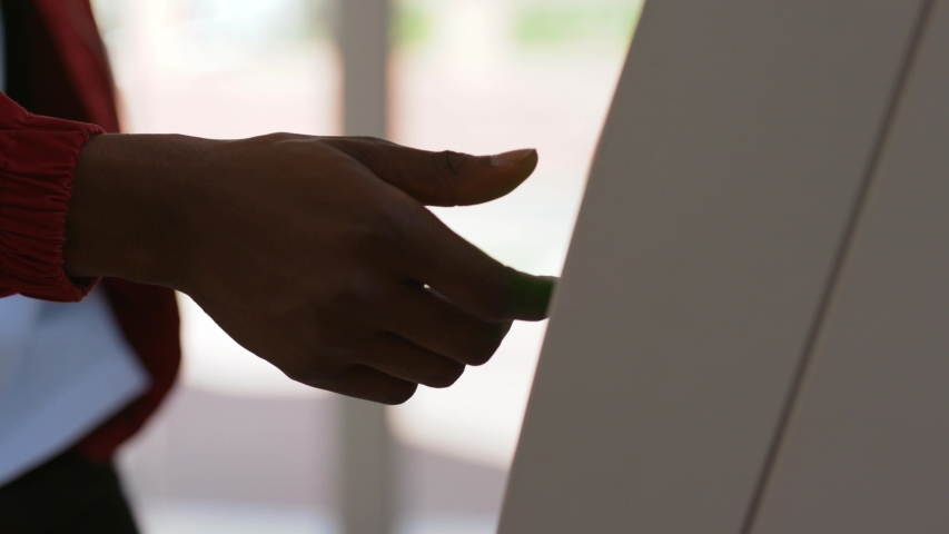 Close-up of african american black man's hand removing a credit card from a cash dispenser. Young man using an ATM machine inside the bank. Royalty-Free Stock Footage #1031464847