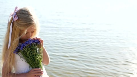 Portrait of a little girl with flowers in her hands