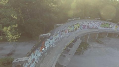 BOSNIA - CIRCA 2018 - Drone aerial of bikers riding fast in a former Olympic bobsled track near Sarajevo, Bosnia.