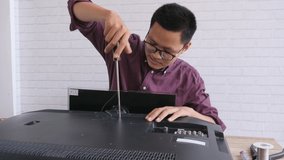 Asian TV repairman working in repair television and service shop