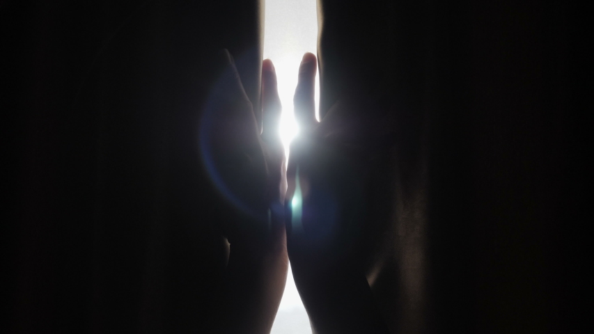 Hands pulling a window curtain for warm morning light. Slow motion.  Young woman opening curtains in a bedroom. Closeup. Femele hands open window curtain in morning.   Royalty-Free Stock Footage #1031484557