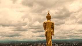 stormy and cloud is moving golden buddha standing 
