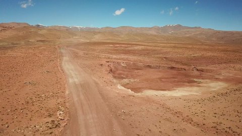 Drone view of an off-road vehicle driving in Morocco desert