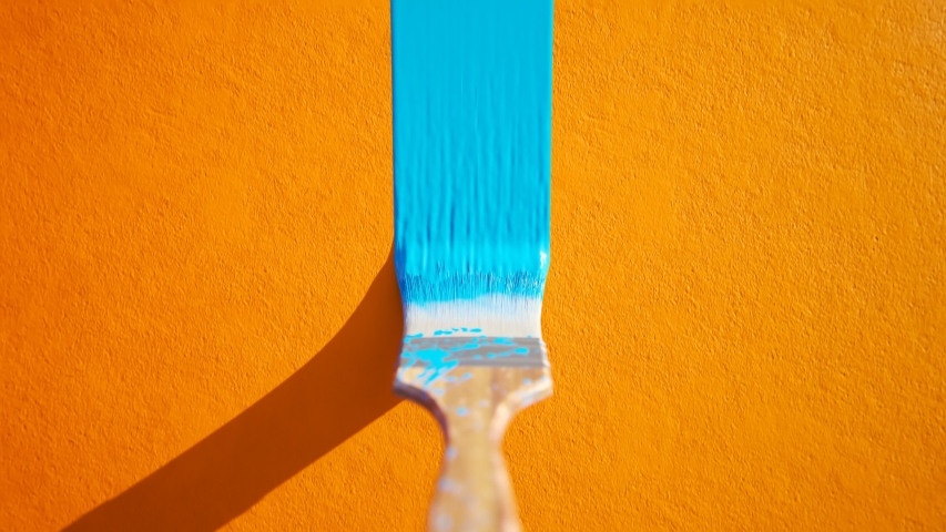 Old, wooden, dirty paintbrush bristle leaving a stripe of colorful, dense, cyan paint on a detailed orange wall. The camera moves along the stripe in an endless, seamless looping animation.
 Royalty-Free Stock Footage #1031514629