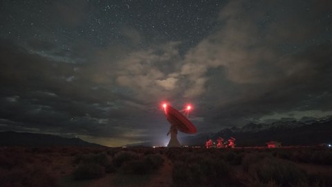 Large radio dish moving at night under the Milky Way Galaxy from Owens Valley Radio Observatory in Big Pine California 