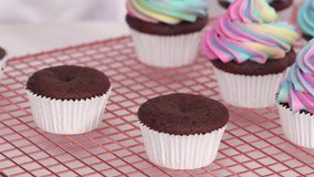 Step by step. Frosting unicorn chocolate cupcakes with rainbow color buttercream frosting. - Powered by Shutterstock - Get 15% off with code: PIKWIZARD15