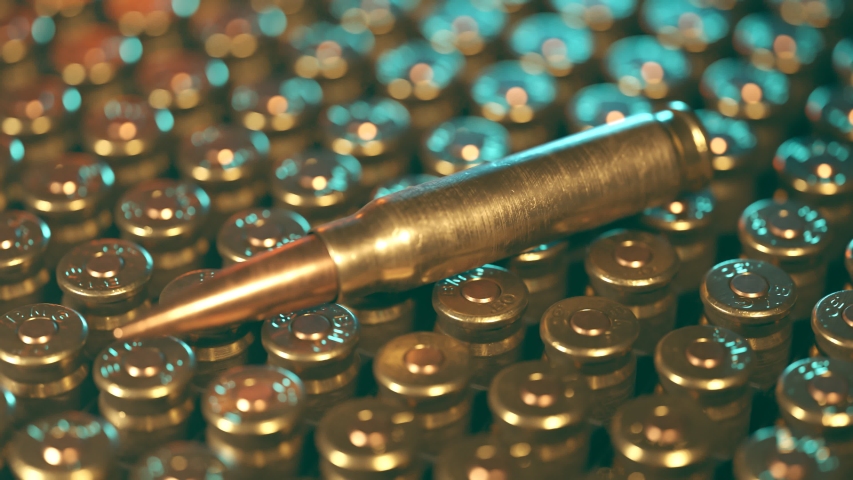 Animation of new, shiny .50 BMG ammunition in a plastic container. One bulllet presented on a large plastic box for machine gun cartridges. Bullet storage. Rows of metallic ammo.
