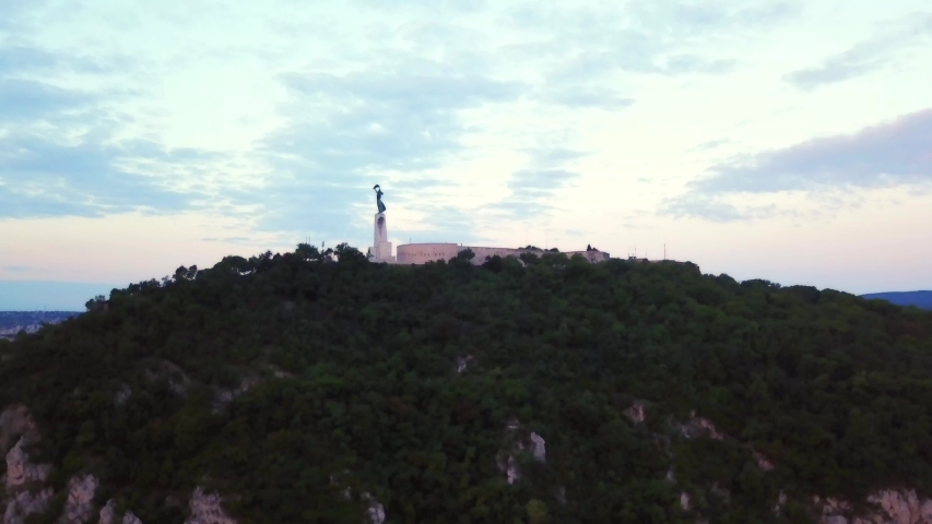Aerial footage by the liberty statue of Budapest, Hungary, with a general view the city.