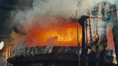 Metal smelting furnace in steel mill. Molten metal pouring, metallurgy, steel casting foundry. Steel manufacturing