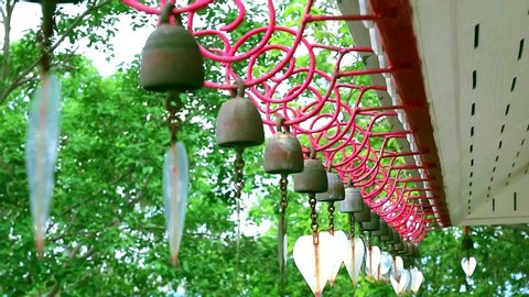 Bells hanging in a row by the wind roof of temple