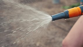 gardening garden lifestyle care concept. splashing water slow motion video . woman holding a garden hose watering. Gardener the vegetable with watering hose and water sprayer